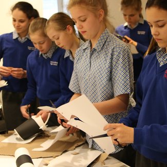 girls_cutting_paper_at_table